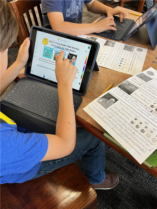 Photo of a student iPad working on the Seesaw app, voting on books they've read